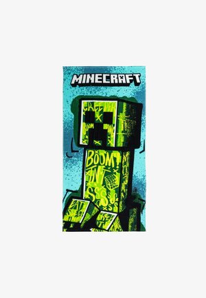 Serviette sur le thème de Minecraft avec un design de Creeper vert et noir sur un fond bleu, ornée de texte en gras et de détails graphiques.