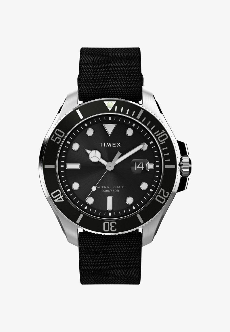 Timexi kell musta tekstureeritud rihmaga, roostevabast terasest korpus, must nägu, helendavad käed ja markerid, millel on ühesuunaline raam.