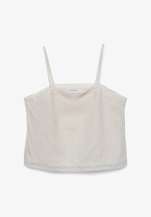 Camisole courte de couleur crème avec fines bretelles et bordure en dentelle le long de l'encolure et de l'ourlet, étiquette taille petite.