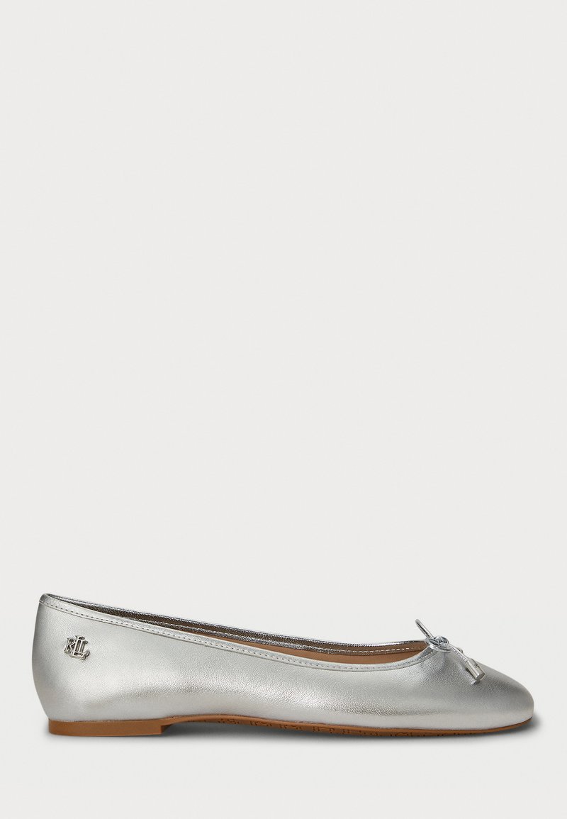 Silver leather ballet flat featuring a rounded toe, thin bow accent, and a small brand emblem on the heel. Smooth metallic texture.