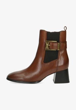 Brown leather ankle boot with a pointed toe, elastic side panels, and a gold buckle accent. Features a textured black block heel.