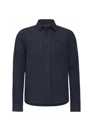 Nappapaita tummansinisestä puuvillakankaasta, jossa on kauluspääntie, kaksi rintataskua ja normaali mitoitus pitkillä hihoilla.