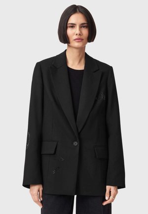 Sort blazer med en skræddersyet design, der har en enkelt knaplukning og dekorativ syning på ærmerne. Fremstillet af et struktureret stof.