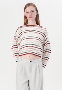 Crochet knit sweater with horizontal multicolored stripes in red, black, and cream. Features a wide neckline and cropped design.