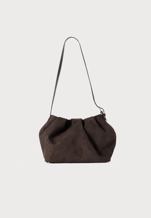 Brown suede shoulder bag with a soft, gathered design. Features a single adjustable strap and a metal clasp detail.