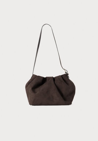 Brown suede shoulder bag with a soft, gathered design. Features a single adjustable strap and a metal clasp detail.