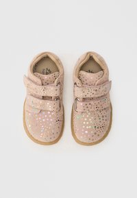 Pink suede toddler shoes with two adjustable velcro straps, featuring a speckled pattern of colorful holographic dots and a rubber sole.