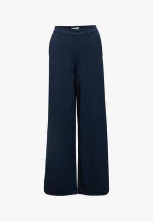 Wide-leg trousers made of navy fabric. Features an elastic waistband, front pockets, and a smooth texture. Tailored design with minimal stitching.