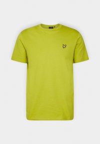 T-shirt di cotone verde lime con maniche corte e scollatura a girocollo, caratterizzata da un piccolo logo di un uccello nero sul lato sinistro del petto.
