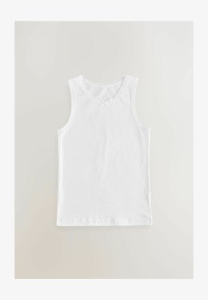 Top de algodón blanco sin mangas con escote redondo, que presenta un borde con puntillas y un pequeño lazo en el centro. Diseño simple y sin mangas.