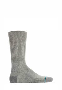 Grå ribbede sokker med forstærket hæl, glat tå søm og en turkis accent ved tåen. Stoffet ser blødt og slidstærkt ud.