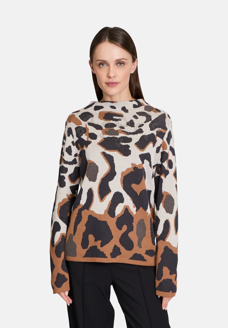 Knit sweater featuring a brown, black, and cream leopard print design, with a round neckline and long sleeves, made from soft fabric.