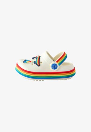 White clogs with a rainbow-striped sole. Features a colorful design with accents, including a rainbow embellishment and adjustable strap.