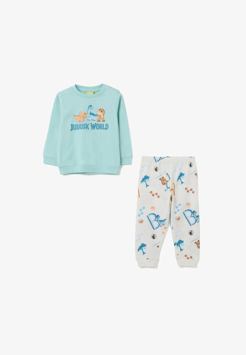 Camisa de manga larga azul claro con gráfico de "Jurassic World"; pantalones de pijama crema con estampados de dinosaurios coloridos y acentos. Tejido de algodón suave.