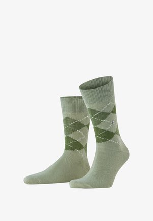 Groene argyle patroon sokken met ribgebreide boorden, gemaakt van zacht materiaal. Bevat lichte en donkere groene diamanten met witte accenten.