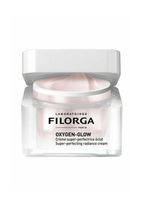 Clear plastic jar with a white lid, containing soft pink cream; labeled "Oxygen-Glow" in black text, sleek and modern design.