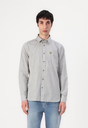 Long-sleeve button-up shirt in black and white checkered pattern. Features a small yellow logo on the left chest. Cotton material.