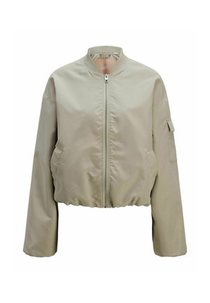 Giacca bomber cropped in beige chiaro, con zip frontale, colletto alto e tasche laterali con una finitura in tessuto testurizzato. Orlo elasticizzato.