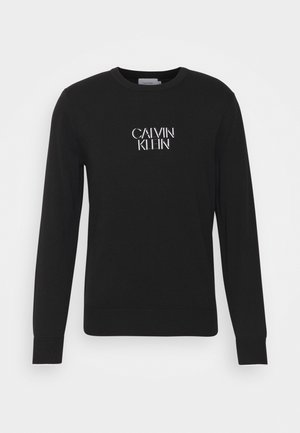 Schwarzer Sweatshirt aus Baumwolle, mit langen Ärmeln und Rundhalsausschnitt. Auf der Brust ist das weiße "CALVIN KLEIN"-Logo aufgedruckt.
