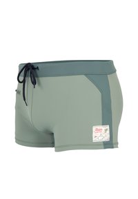 Maillot de bain vert en tissu extensible, doté d'une taille à cordon de serrage, d'une poche latérale et d'un petit patch décoratif.