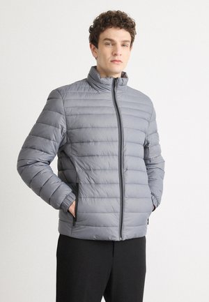 Gray quilted puffer jacket with a high collar, front zipper, and elastic cuffs. Features side pockets and a textured fabric.