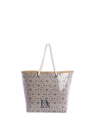 Bolso tote beige con patrón floral geométrico negro, asas de cuerda e iniciales "DA" en la parte frontal, sobre un fondo blanco.