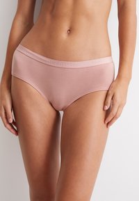Ljust rosa bomullsunderkläder med en slät yta och ett brett, elastiskt midjeband som har en subtil logotryck.