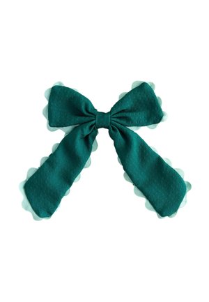 Dark green fabric bow with scalloped light green lace trim against a white background.