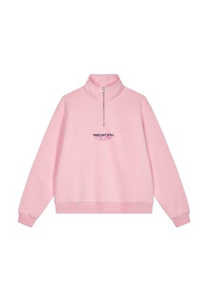 Pink, cotton-blend sweatshirt with a high collar and half-zip closure. Features embroidered text "TIRED BUT STILL ON TIME" in black and blue.