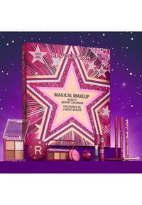 Calendrier de l'Avent beauté de maquillage magique dans une boîte en étoile, rose et violet, contenant divers cosmétiques, y compris des rouges à lèvres et des palettes.