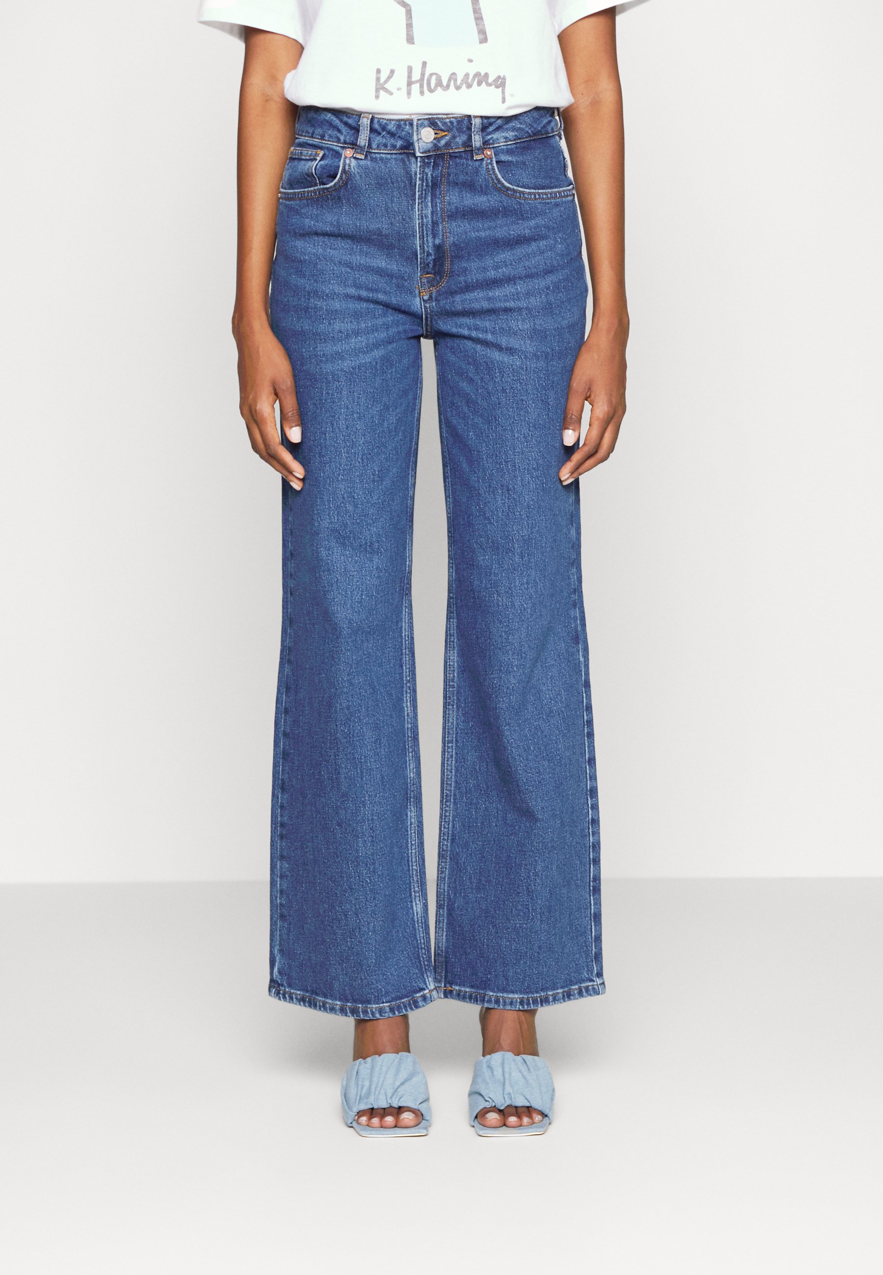 Jeans a zampa strappati con orlo sfrangiato - Multibrand Store