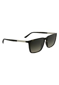 Lunettes de soleil en écaille de tortue avec des verres dégradés foncés, monture carrée et accent en argent sur les branches. Présente des extrémités de branches proéminentes.