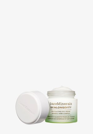 Vaso bianco con accenti verdi, contenente una crema occhi rivitalizzante. Il coperchio è liscio e la consistenza cremosa è visibile, etichettato "bareMinerals Skinlongevity".