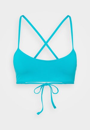 Haut de bikini turquoise avec un design à dos croisé, lien ajustable en bas, et tissu lisse et extensible pour le confort.