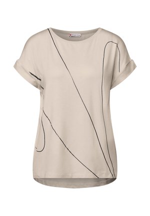 T-shirt beige con scollo rotondo e maniche corte arrotolate. Presenta motivi astratti di linee nere sulla parte anteriore. Tessuto morbido e liscio.
