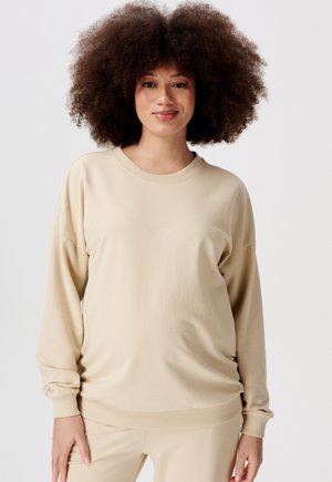 Beiger Pullover mit langen Ärmeln, gerippten Bündchen und Saum, aus einem weichen, glatten Material gefertigt. Einfaches Design mit Rundhalsausschnitt.
