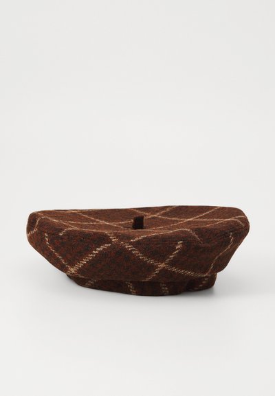 Brown plaid beret made of textured wool, featuring a top button, curved edge, and white check pattern, creating a distinct visual design.