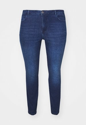 Dunkelblaue Jeans aus Denim mit enganliegendem Schnitt, fünf Taschen und Reißverschluss. Besitzt dezente Auswaschungen und Nahtdetails entlang der Nähte.