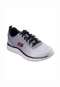 Scarpa sportiva grigia con tomaia in rete, accenti neri e suola bianca spessa. Presenta lacci e un logo sul lato. Superficie testurizzata.