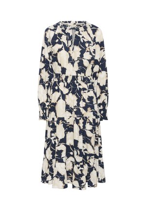 Langdurige mouw, marineblauwe jurk met een bloemenpatroon in crèmekleur. Heeft een geplooid middenstuk en een gelaagde rok, gemaakt van een lichte stof.