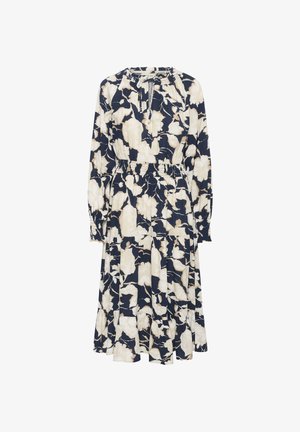 Langdurige mouw, marineblauwe jurk met een bloemenpatroon in crèmekleur. Heeft een geplooid middenstuk en een gelaagde rok, gemaakt van een lichte stof.
