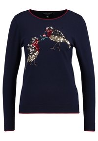Maglione a maniche lunghe blu navy con rifiniture rosse, caratterizzato da due uccelli di paillettes rivolti l'uno verso l'altro, uno dei quali tiene un piccolo fiore nel becco.