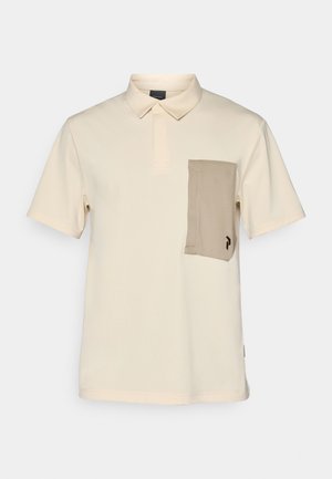 Polo shirt in light beige with a collared design, short sleeves, and a contrasting tan pocket featuring a logo. Smooth, lightweight fabric.