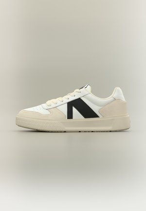 Witte en beige leren sneaker met zwarte zijstrook en beige rubberen zool, zijaanzicht op een neutrale achtergrond.