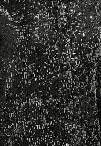 Schwarzer Paillettenstoff mit schimmernder Textur, dicht bedeckt mit runden Pailletten, die das Licht reflektieren und einen funkelnden Effekt erzeugen.