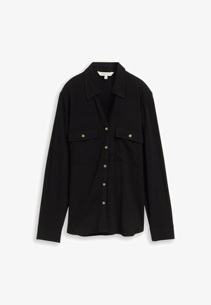 Schwarzes Hemd mit Knopfleiste und langen Ärmeln, zwei Brusttaschen, goldfarbene Knöpfe und einen kragenbetonten Ausschnitt. Hergestellt aus weichem, leichtem Stoff.