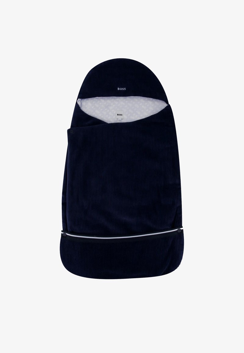 Donkerblauwe corduroy slaapzak voor baby's met witte, gemusterde voering en een zwarte rits aan de onderkant. Merkenlogo zichtbaar aan de bovenkant.