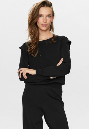 Sweatshirt noir à manches longues, avec des poignets côtelés et de délicates volants aux épaules. Texture douce, coupe décontractée et col rond.