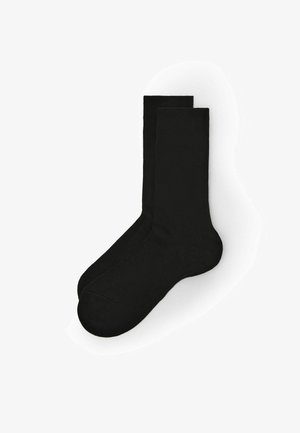 Calze di cotone nere con una texture liscia, lunghezza standard e aree rinforzate per le dita dei piedi e il tallone per una maggiore durata.