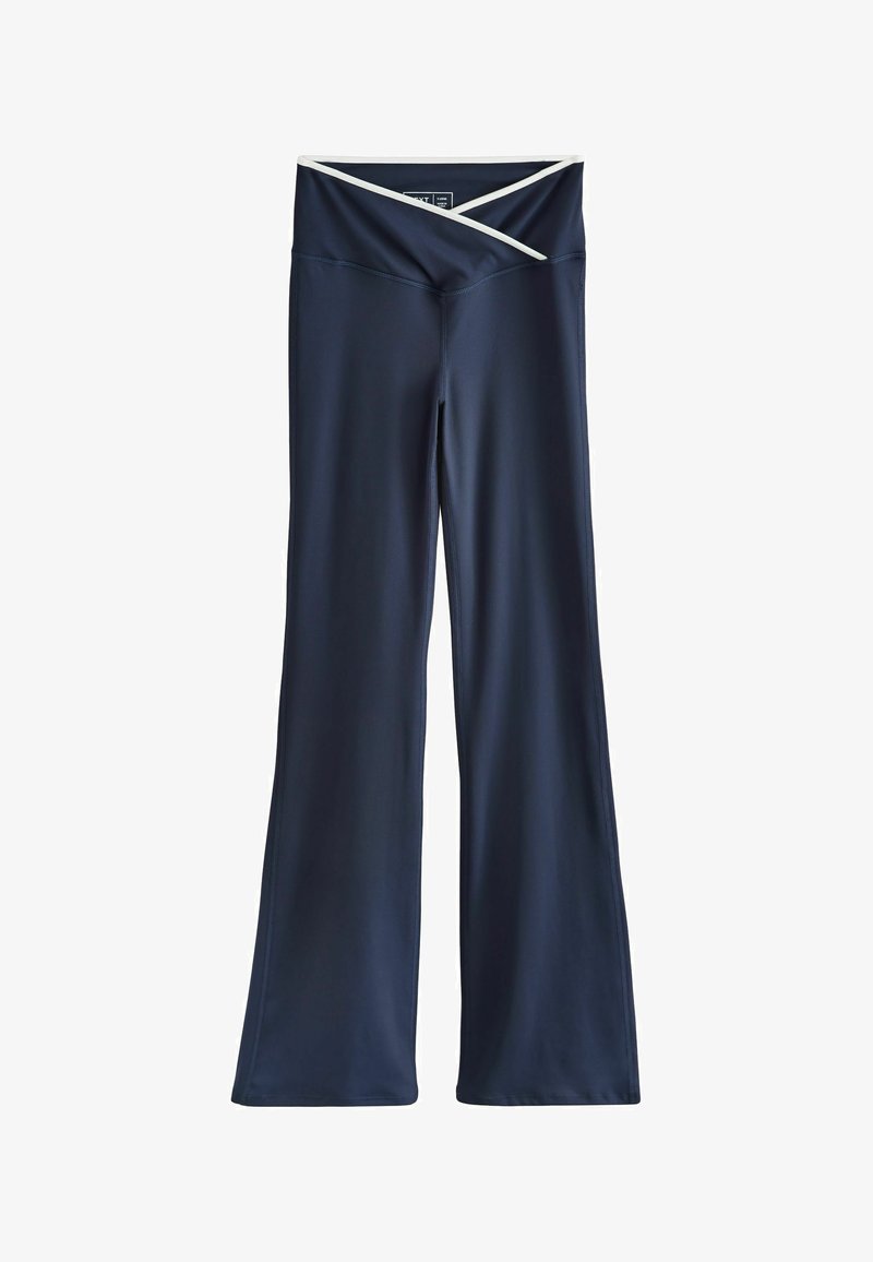Pantalon de yoga bleu marine à jambes larges avec une taille croisée couleur crème.
